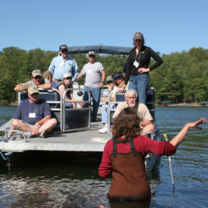 A female instructor teaching a group of learners on a pontoon boat