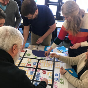 A land use specialist demonstrating how to play a decision game
