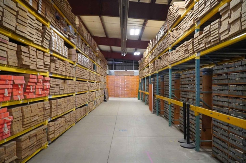 An isle of a warehouse that is full of core samples on shelves