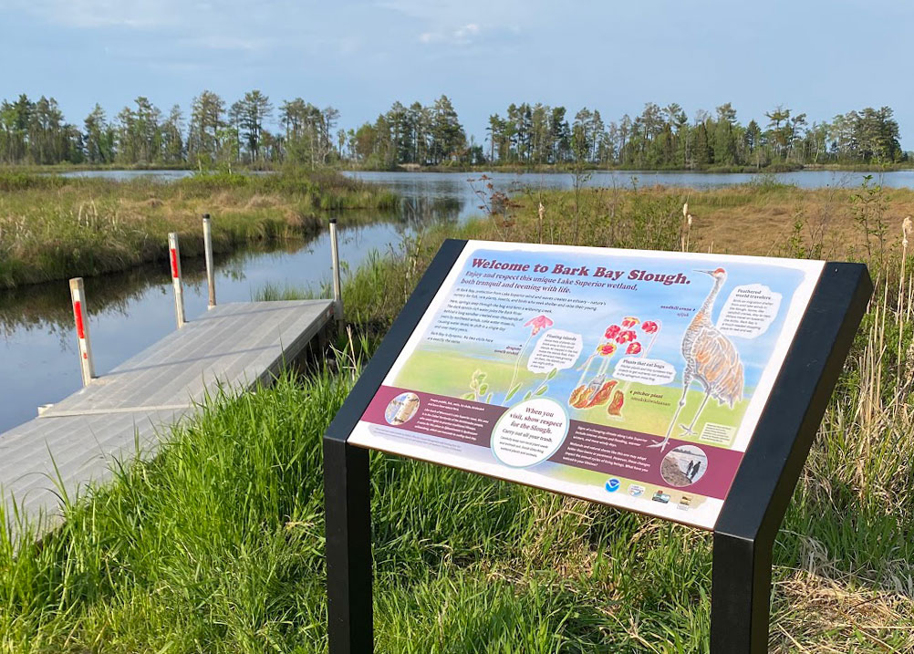 An interpretative sign by a boat launch