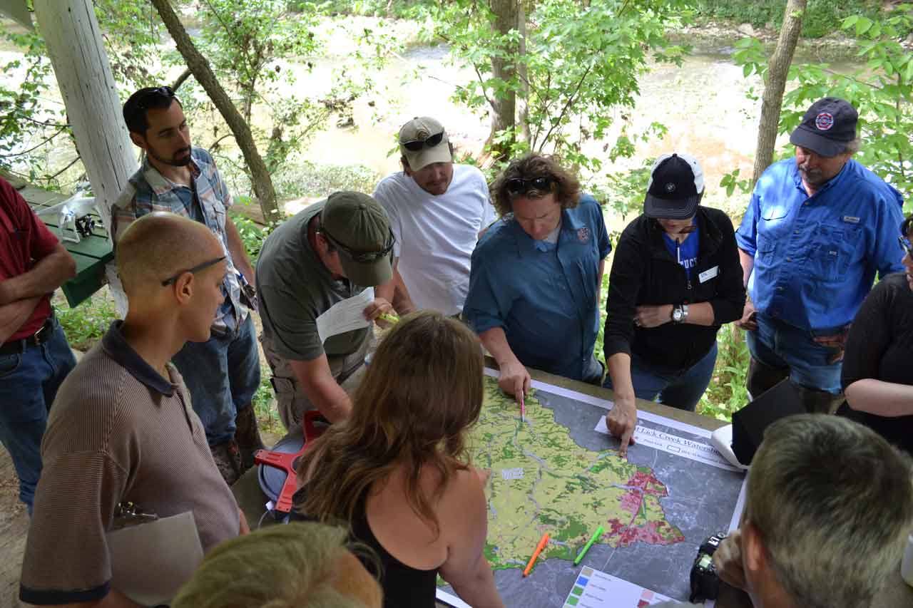 A group of people looking at a map