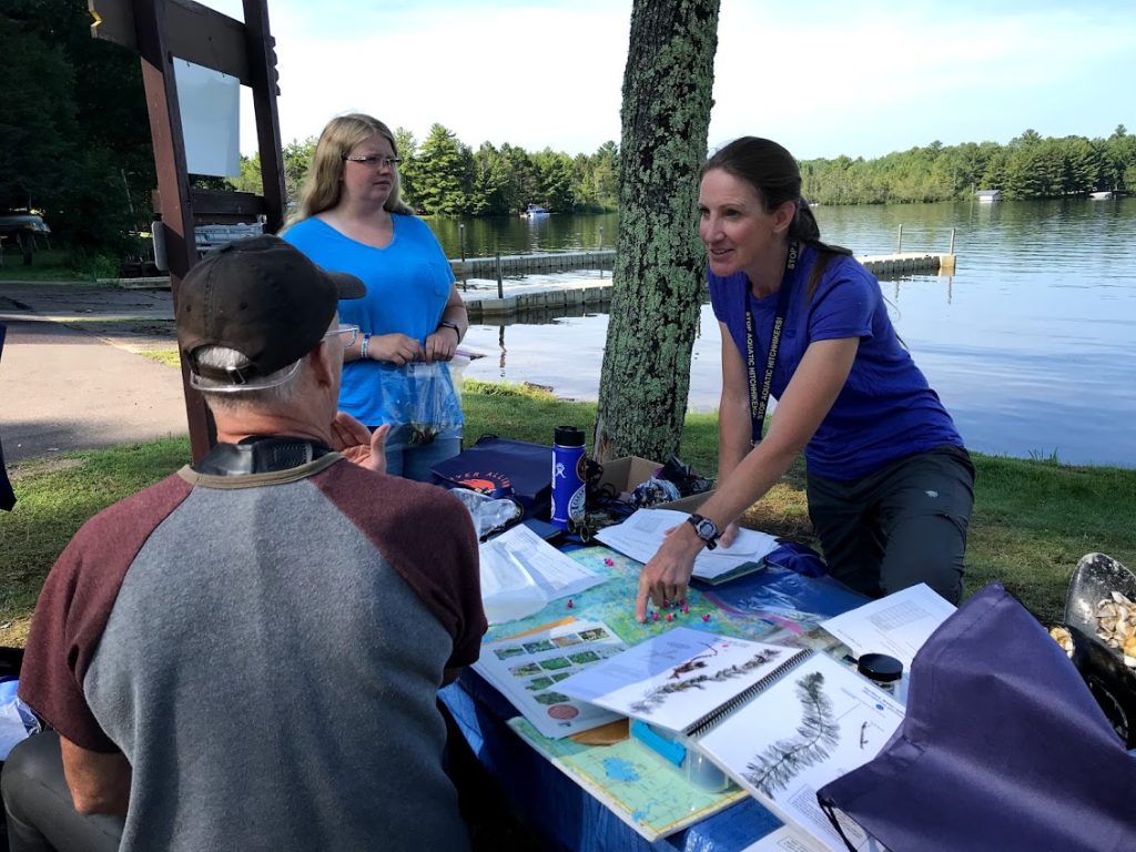 A site coordinator points to monitoring sites on a map