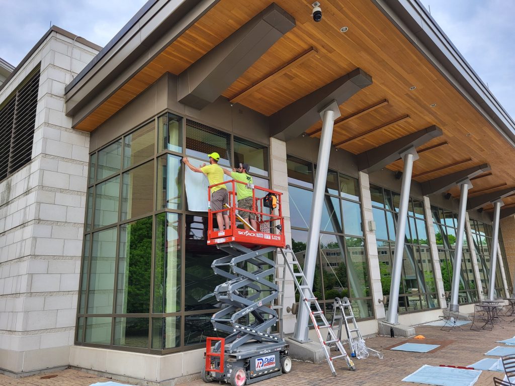 Workers install bird-friendly windows at Dejope