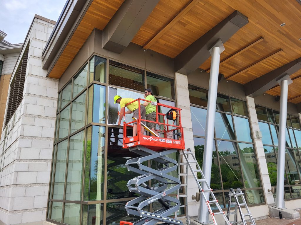 Workers install bird-friendly windows at Dejope