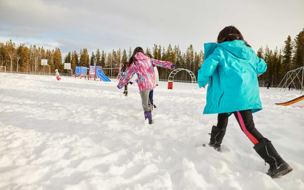 Young kids playing in a snow covered school playground
