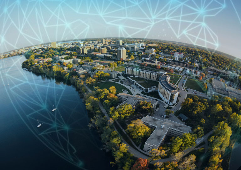 An aerial view of the UW Madison campus with a geometric design overlaid