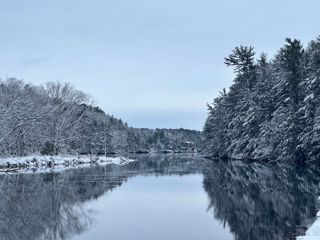 A river flowing through a snow covered forest