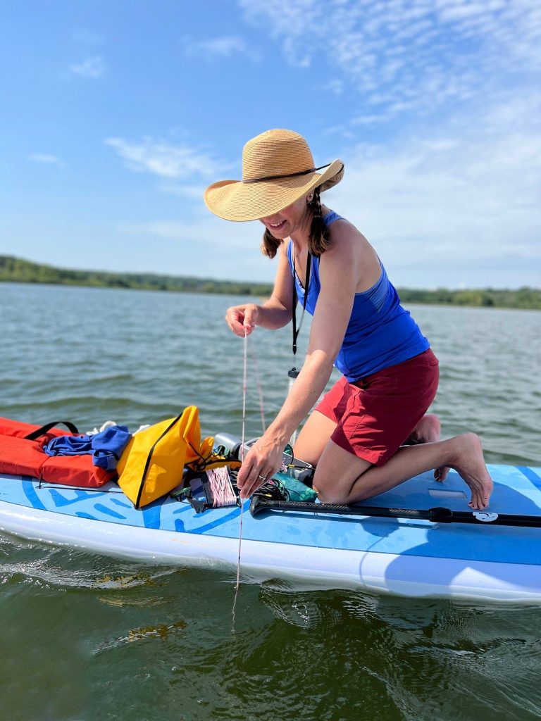 A citizen lake monitoring network volunteer taking a water clarity reading