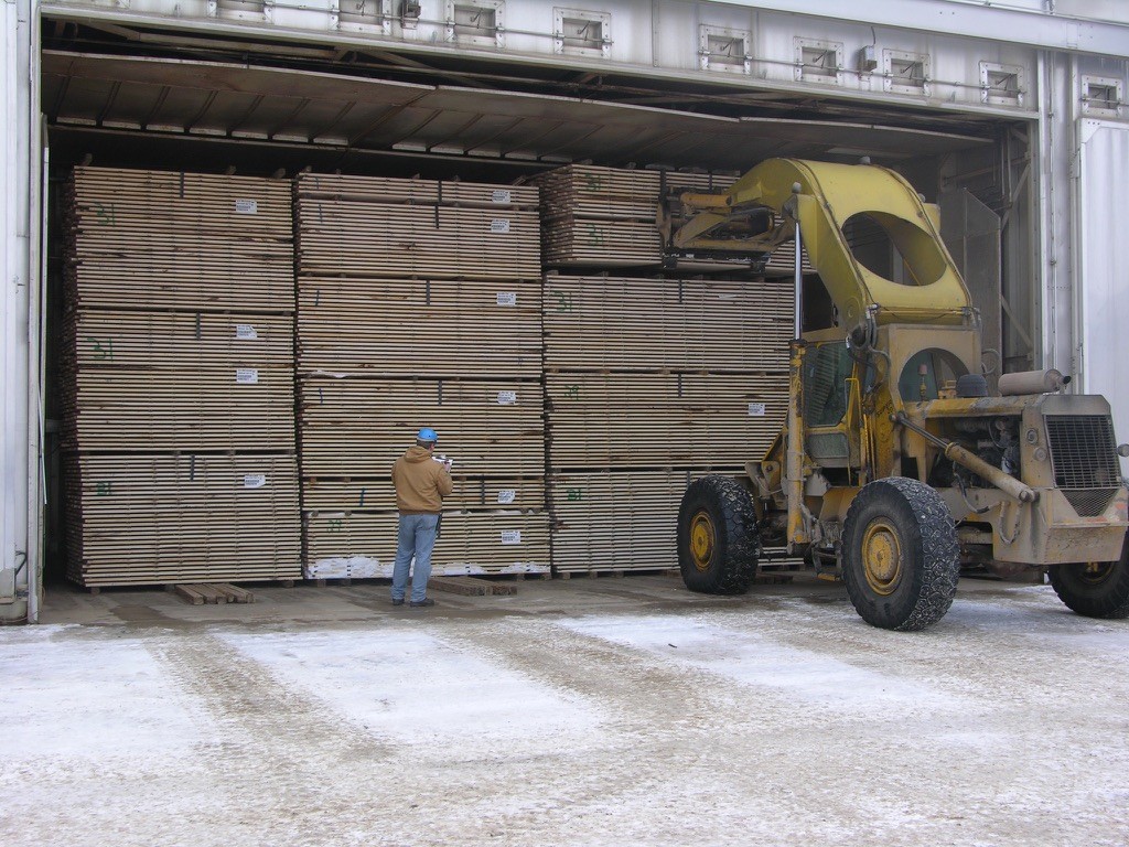 A hardwood lumber dry kilns being loaded.
