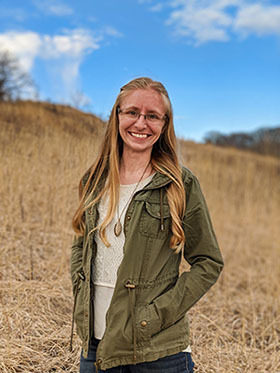 Headshot of Maranda Miller standing in a field outside
