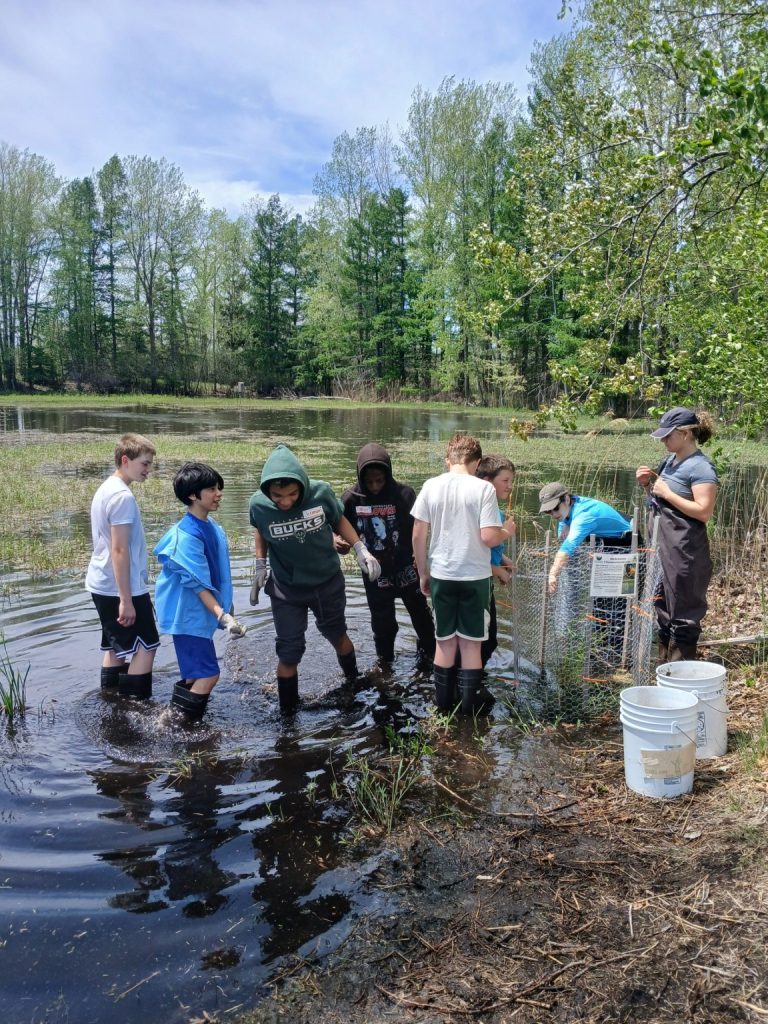 A group of school age students standing in the bay of Green Bay